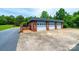 Detached four car garage with white doors, brick accents, and concrete driveway at 4275 Herman Sipe Rd, Conover, NC 28613