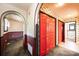 Hallway featuring unique wallpaper and adjacent room with wainscoting and red wall paneling at 4275 Herman Sipe Rd, Conover, NC 28613