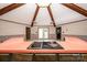 Well-lit kitchen with a skylight, cooktop island, wood beams and neutral toned walls at 4275 Herman Sipe Rd, Conover, NC 28613