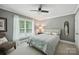 Cozy bedroom with neutral tones, ceiling fan, natural light, and comfortable furnishings at 4824 Waxhaw Farms Rd, Waxhaw, NC 28173