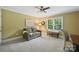 Comfortable bedroom showcasing a sofa, bench, large window, and ceiling fan at 4824 Waxhaw Farms Rd, Waxhaw, NC 28173