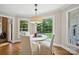 Cozy dining area with hardwood floors, bright windows, and outdoor views of the home's backyard at 4824 Waxhaw Farms Rd, Waxhaw, NC 28173