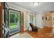 A bright foyer with hardwood floors, decorative glass front door and sidelight, leading into the home at 4824 Waxhaw Farms Rd, Waxhaw, NC 28173