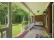 Inviting front porch with swing, brick accents, and well-maintained landscaping, perfect for relaxing outdoors at 4824 Waxhaw Farms Rd, Waxhaw, NC 28173