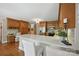 The kitchen features custom wood cabinets, stainless steel appliances, and quartz countertops with barstool seating at 4824 Waxhaw Farms Rd, Waxhaw, NC 28173