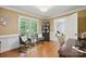 Inviting living room featuring hardwood floors, large windows, and a comfortable seating arrangement at 4824 Waxhaw Farms Rd, Waxhaw, NC 28173