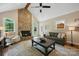 Spacious living room featuring a stone fireplace, high ceilings, and a cozy seating area at 4824 Waxhaw Farms Rd, Waxhaw, NC 28173