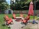 Cozy backyard featuring a fire pit and Adirondack chairs, perfect for outdoor entertaining at 5017 Celeste Ct, Charlotte, NC 27609