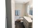 Bathroom featuring a gray vanity with modern fixtures and a mirror with lighting at 5017 Celeste Ct, Charlotte, NC 27609