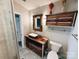 Bathroom with rustic wood vanity, vessel sink, tiled shower, and modern fixtures at 5017 Celeste Ct, Charlotte, NC 27609
