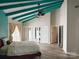 Spacious bedroom with vaulted ceilings, fan, and large closet with mirrored doors at 5017 Celeste Ct, Charlotte, NC 27609