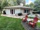 Charming home featuring a lush lawn, inviting porch, and well-manicured landscaping at 5017 Celeste Ct, Charlotte, NC 27609