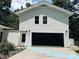 Garage with blue stepping stones as decor leading up to the entrance door at 5017 Celeste Ct, Charlotte, NC 27609