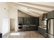 Modern kitchen featuring stainless steel appliances, gray cabinets, and vaulted ceilings at 5017 Celeste Ct, Charlotte, NC 27609