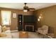 Comfortable living room boasts a fireplace, ceiling fan, and neutral color palette at 5017 Celeste Ct, Charlotte, NC 27609