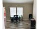 Empty office with one window and a glass table with laminate hardwood floors at 5017 Celeste Ct, Charlotte, NC 27609