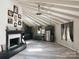 Open floorplan including kitchen and fireplace with vaulted ceiling and hardwood floors at 5017 Celeste Ct, Charlotte, NC 27609