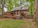 Log cabin home featuring a covered deck, hot tub, wooded yard, and a metal roof at 5109 Walnut Grove Ln, Charlotte, NC 28227