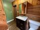 Bathroom with wood paneled walls, dark vanity with granite top, and modern toilet at 5109 Walnut Grove Ln, Charlotte, NC 28227