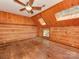 This is a bedroom with a wooden floor, walls, ceiling fan, and skylights at 5109 Walnut Grove Ln, Charlotte, NC 28227