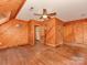 This is a bedroom with a wooden floor and walls, ceiling fan, and multiple doorways at 5109 Walnut Grove Ln, Charlotte, NC 28227