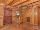Foyer with hardwood floors, wooden walls, and a staircase leading to the upper floor at 5109 Walnut Grove Ln, Charlotte, NC 28227