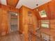 Hallway with hardwood floors and a wooden banister leading to the upper floor, offering a glimpse of the neighborhood at 5109 Walnut Grove Ln, Charlotte, NC 28227