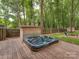Relax in this backyard hot tub with a privacy fence, wooden deck, and storage, surrounded by lush greenery at 5109 Walnut Grove Ln, Charlotte, NC 28227