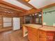 The kitchen includes wooden cabinets, tile countertops, an island, and a stone fireplace in the background at 5109 Walnut Grove Ln, Charlotte, NC 28227