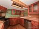 A well-equipped kitchen showcases wooden cabinets, tile countertops, stainless steel appliances, and a skylight providing natural light at 5109 Walnut Grove Ln, Charlotte, NC 28227