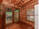 The kitchen features wood-finished walls, wooden floor, and sliding doors leading to a deck with an outdoor dining set at 5109 Walnut Grove Ln, Charlotte, NC 28227