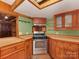 The kitchen offers wooden cabinets, tile countertops, stainless steel appliances, and a skylight providing natural light at 5109 Walnut Grove Ln, Charlotte, NC 28227