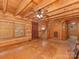 Spacious living room with staircase, wood walls, beamed ceilings, and natural light at 5109 Walnut Grove Ln, Charlotte, NC 28227