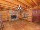 Cozy living room with a stone fireplace, wood walls and ceilings, and natural light at 5109 Walnut Grove Ln, Charlotte, NC 28227