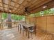 This is a patio with a wood ceiling, a fan, and a table with chairs at 5109 Walnut Grove Ln, Charlotte, NC 28227