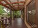 Covered porch with wood floors and ceiling, showcasing the log cabin's natural aesthetic at 5109 Walnut Grove Ln, Charlotte, NC 28227