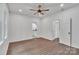 Bright bedroom featuring a ceiling fan, wood-look flooring, and access to an ensuite bathroom at 512 North Mulberry St, Cherryville, NC 28021