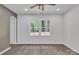Well lit bedroom with hardwood floors, neutral paint and a large window at 512 North Mulberry St, Cherryville, NC 28021