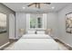 Light-filled bedroom boasts a large window with backyard views, bedside tables, and calming decor at 512 North Mulberry St, Cherryville, NC 28021