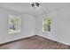 Bright bedroom features wood-look floors, natural light from two windows at 512 North Mulberry St, Cherryville, NC 28021