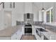Sleek eat-in kitchen features stainless appliances, stylish backsplash, and plenty of storage at 512 North Mulberry St, Cherryville, NC 28021