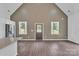 Bright living area with a vaulted ceiling, hardwood floors, and two windows providing natural light at 512 North Mulberry St, Cherryville, NC 28021