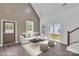 Bright living room featuring a vaulted ceiling, modern sofa, wood floors, and abundant natural light at 512 North Mulberry St, Cherryville, NC 28021