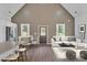 Inviting living room features a vaulted ceiling, modern sofa, wood floors, and an eat-in kitchen space at 512 North Mulberry St, Cherryville, NC 28021