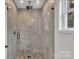 Step into a spa-like shower with stunning tile work, a rain shower head, and sleek glass enclosure at 512 North Mulberry St, Cherryville, NC 28021