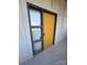Apartment front door with window sidelight, framed in gray with a yellow door at 514 W 10Th St # 403, Charlotte, NC 28202