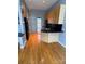 Functional kitchen with hardwood floors, black appliances and a breakfast bar at 514 W 10Th St # 403, Charlotte, NC 28202
