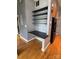 Built-in office nook adjacent to kitchen with black shelving and hardwood flooring at 514 W 10Th St # 403, Charlotte, NC 28202