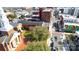Aerial view overlooking city street, red brick buildings, mural art, and mature trees at 54 Reed Ne St, Concord, NC 28025