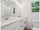 Bathroom with dual sink vanity with white countertops and wood-look floors at 54 Reed Ne St, Concord, NC 28025
